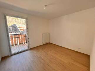 Discover this bright and airy room featuring a large glass door that opens to a charming balcony with scenic views.