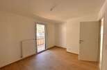 Discover this bright and airy room featuring a modern radiator and a large glass door leading to a balcony with scenic views.