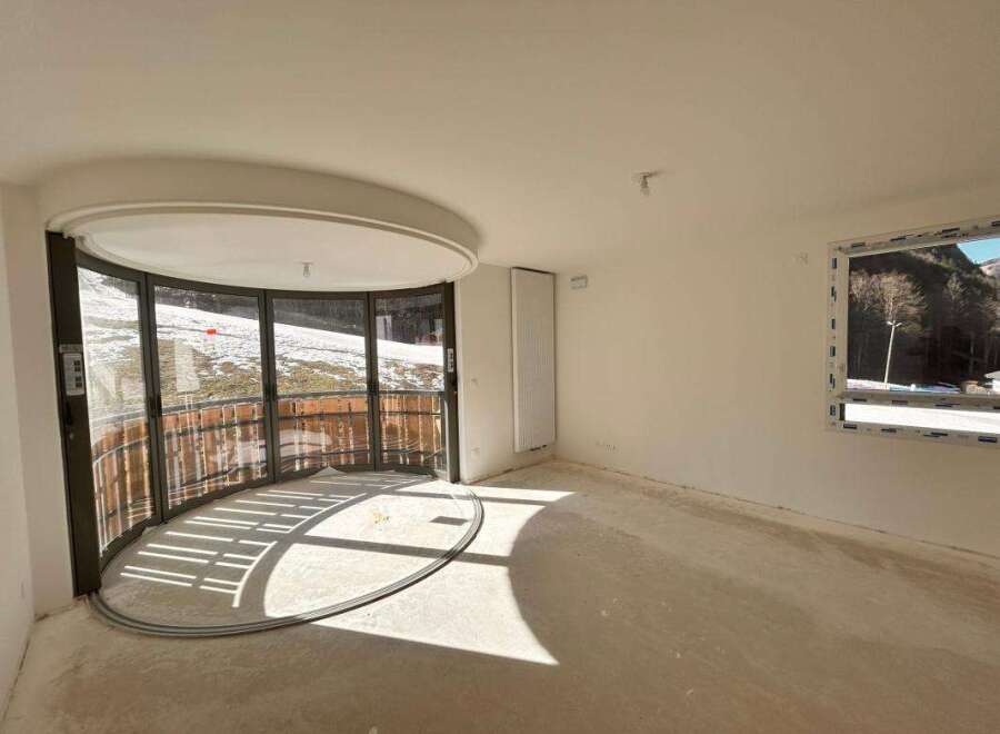 Experience breathtaking mountain views from this unique curved balcony, perfect for enjoying the serene winter landscape.