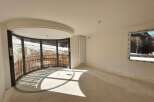 Experience breathtaking mountain views from this unique curved balcony, perfect for enjoying the serene winter landscape.
