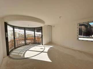 Experience breathtaking mountain views from this unique curved balcony, perfect for enjoying the serene winter landscape.