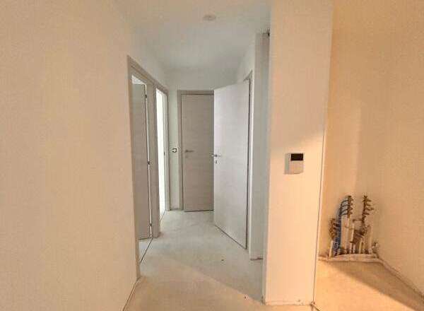 Explore this spacious hallway, featuring multiple doorways leading to different rooms.