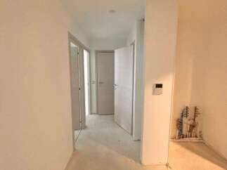 Explore this spacious hallway, featuring multiple doorways leading to different rooms.