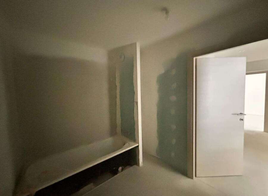 Discover the potential of this unfinished bathroom, featuring a classic bathtub ready for your personal touch.