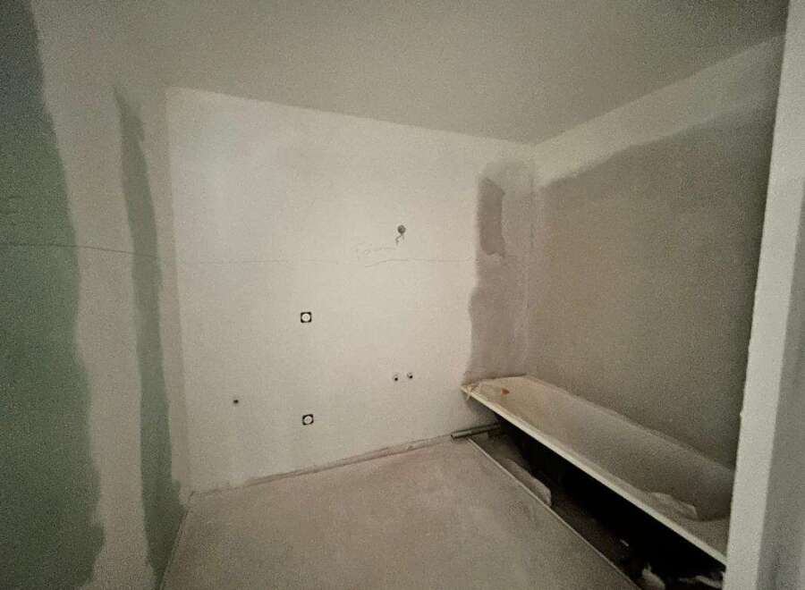 This bathroom is currently undergoing renovation, featuring a bathtub ready for installation.
