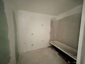 This bathroom is currently undergoing renovation, featuring a bathtub ready for installation.