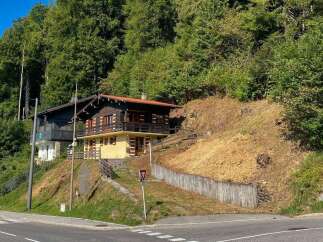 Nestled on a scenic hillside, this charming wooden chalet offers a serene mountain retreat.