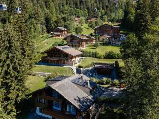 Experience luxury mountain living in this stunning chalet, nestled amidst lush greenery and offering breathtaking views.