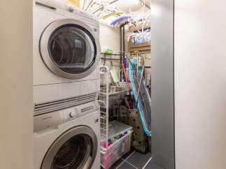 Discover a functional laundry space featuring a stacked Electrolux washer and dryer, perfect for optimizing space.