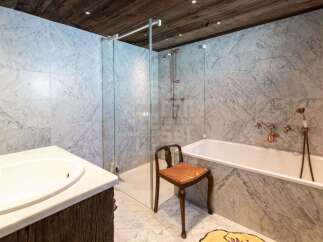 Experience luxury in this stunning bathroom featuring elegant marble tilework throughout.