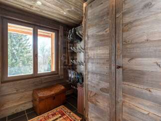 Experience rustic charm in this mountain retreat, featuring a dedicated ski boot and pole storage area.