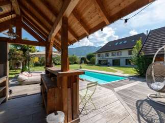 Experience ultimate outdoor living with this stunning property featuring a sparkling swimming pool and a covered bar area perfect for entertaining.