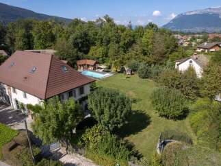 Discover this stunning property featuring a beautiful swimming pool and a spacious green lawn, perfect for outdoor relaxation and entertainment.
