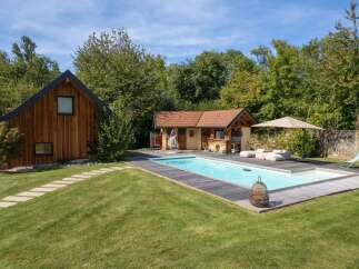 Experience ultimate relaxation in this stunning backyard oasis, featuring a sparkling swimming pool perfect for hot summer days.
