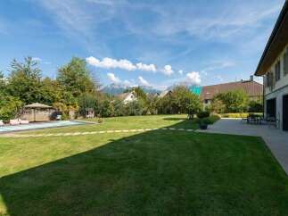 Enjoy the ultimate outdoor living experience in this stunning property featuring a sparkling swimming pool and a spacious, manicured lawn perfect for relaxation and recreation.
