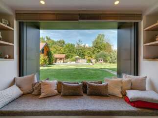 Experience seamless indoor-outdoor living with this stunning view from a cozy window seat.