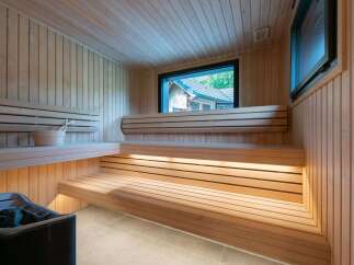 Experience ultimate relaxation in this luxurious sauna, featuring natural wood paneling and ambient lighting.
