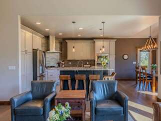 Experience modern living in this open-concept home featuring a gourmet kitchen with a large island and sleek stainless steel appliances.