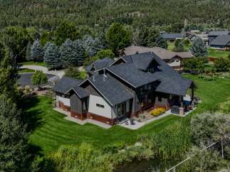 Discover this stunning modern home nestled amidst lush greenery and mature trees, offering a serene retreat.
