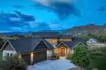 Experience luxury mountain living in this stunning modern home, nestled against a backdrop of majestic peaks.