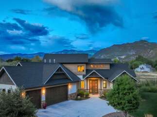Experience luxury mountain living in this stunning modern home, nestled against a backdrop of majestic peaks.