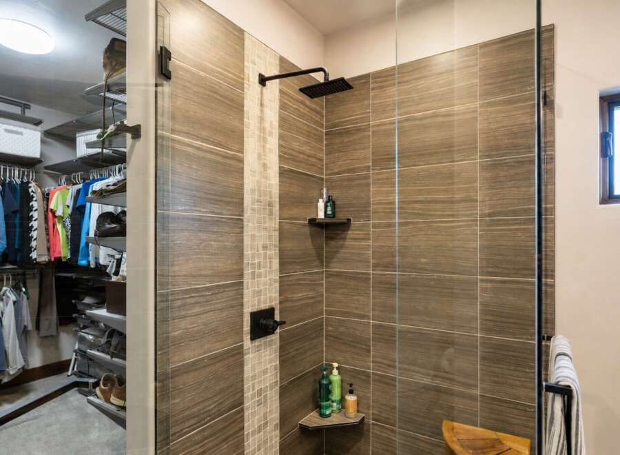 Experience luxury and organization in this stunning master suite, featuring a spacious walk-in closet with ample shelving and hanging space.
