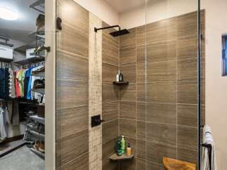 Experience luxury and organization in this stunning master suite, featuring a spacious walk-in closet with ample shelving and hanging space.