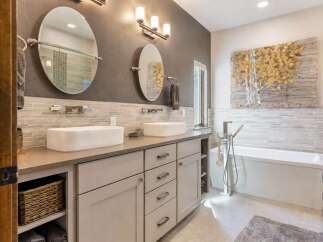 Experience luxury in this modern bathroom featuring a spacious double vanity with vessel sinks and sleek chrome fixtures.