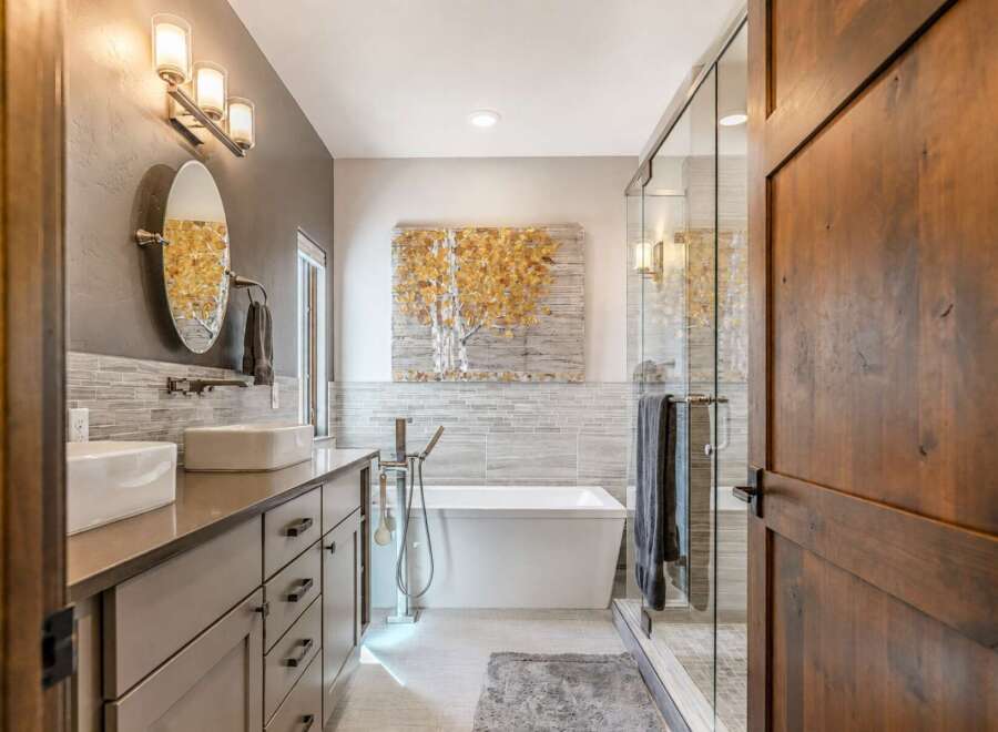 Experience luxury in this modern bathroom featuring a freestanding soaking tub and a spacious glass-enclosed shower.