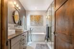 Experience luxury in this modern bathroom featuring a freestanding soaking tub and a spacious glass-enclosed shower.