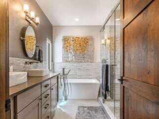 Experience luxury in this modern bathroom featuring a freestanding soaking tub and a spacious glass-enclosed shower.