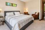 This inviting bedroom features a comfortable king-size bed with a stylish upholstered headboard, perfect for relaxation.