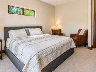 This inviting bedroom features a comfortable king-size bed with a stylish upholstered headboard, perfect for relaxation.