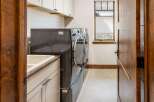 This laundry room features a spacious sink and ample counter space, perfect for folding clothes.