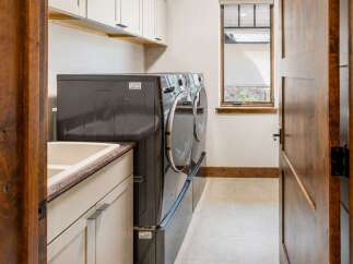 This laundry room features a spacious sink and ample counter space, perfect for folding clothes.