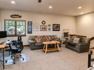 This inviting living space features a comfortable leather sofa and armchair, perfect for relaxing after a long day.