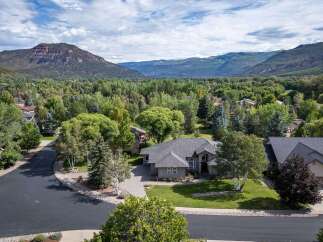 Nestled amidst a lush, tree-lined landscape, this stunning property offers a serene retreat with breathtaking mountain views.