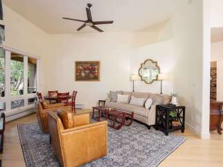 This inviting living room features a plush sectional sofa complemented by two stylish leather armchairs, perfect for relaxation and entertaining.