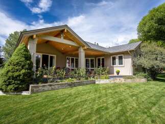 Enjoy outdoor living with this stunning home featuring a spacious covered patio, perfect for entertaining or relaxing.