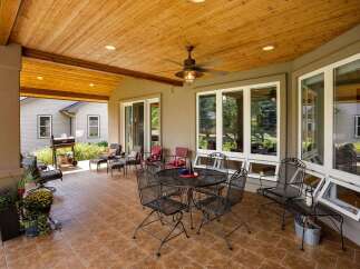 Enjoy outdoor living on this spacious covered patio, perfect for entertaining or relaxing.