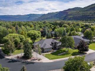 Nestled amidst lush greenery and mature trees, this stunning property offers a serene retreat with breathtaking mountain views.