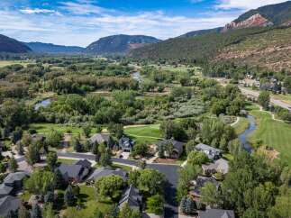 Experience luxury living in this stunning estate nestled beside a serene river and a picturesque golf course.
