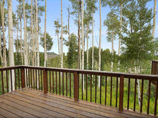 Enjoy the serene mountain views from this spacious wooden deck, perfect for outdoor living and entertaining.