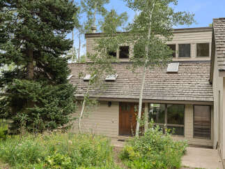 Nestled amidst lush greenery and mature trees, this charming home offers a serene escape.