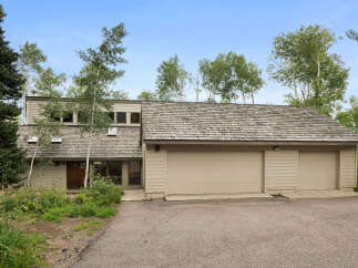Nestled amidst lush greenery and mature trees, this charming home offers a serene retreat.