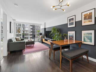 Experience modern urban living in this stylish apartment featuring a spacious living and dining area.