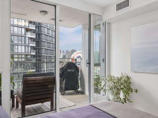 Enjoy stunning city views from this modern apartment featuring a private balcony perfect for outdoor dining or relaxation.