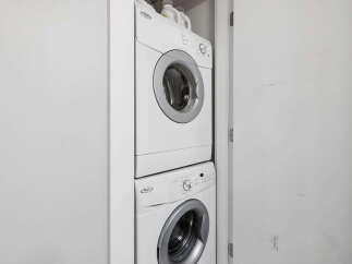 Discover the convenience of in-unit laundry with this stacked washer and dryer set, perfect for maximizing space in your home.
