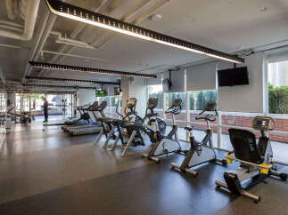 This modern gym features a variety of cardio equipment, including treadmills and stationary bikes, perfect for residents seeking an active lifestyle.