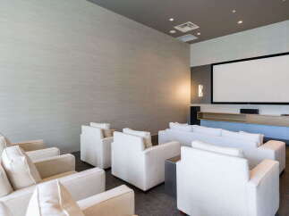 Experience cinematic entertainment in this modern home theater, featuring a large projection screen and plush, comfortable seating arrangements.